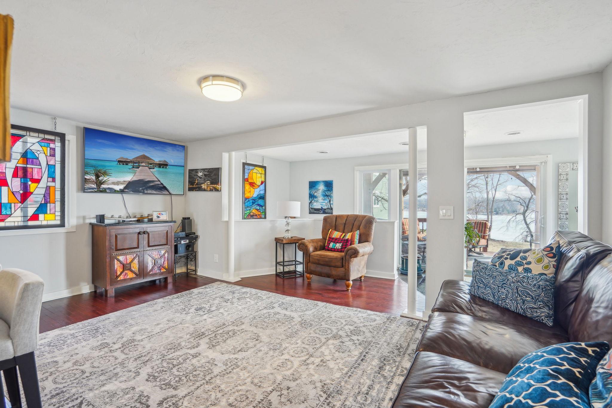 This light and airy living room features plenty of natural light and easy access to the deck, creating an ideal space for indoor-outdoor living.