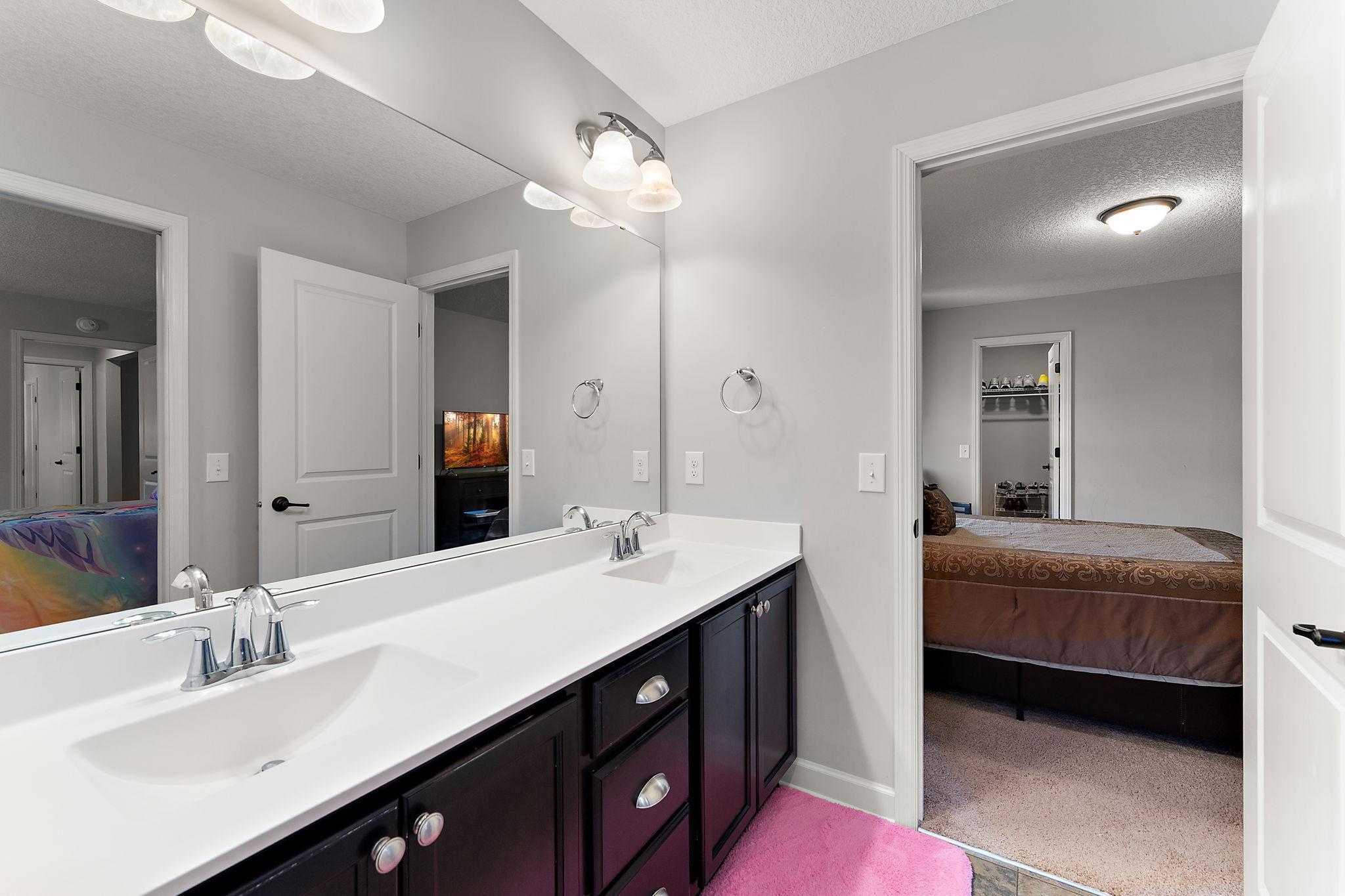Jack N Jill bathroom with dual sinks and large vanity