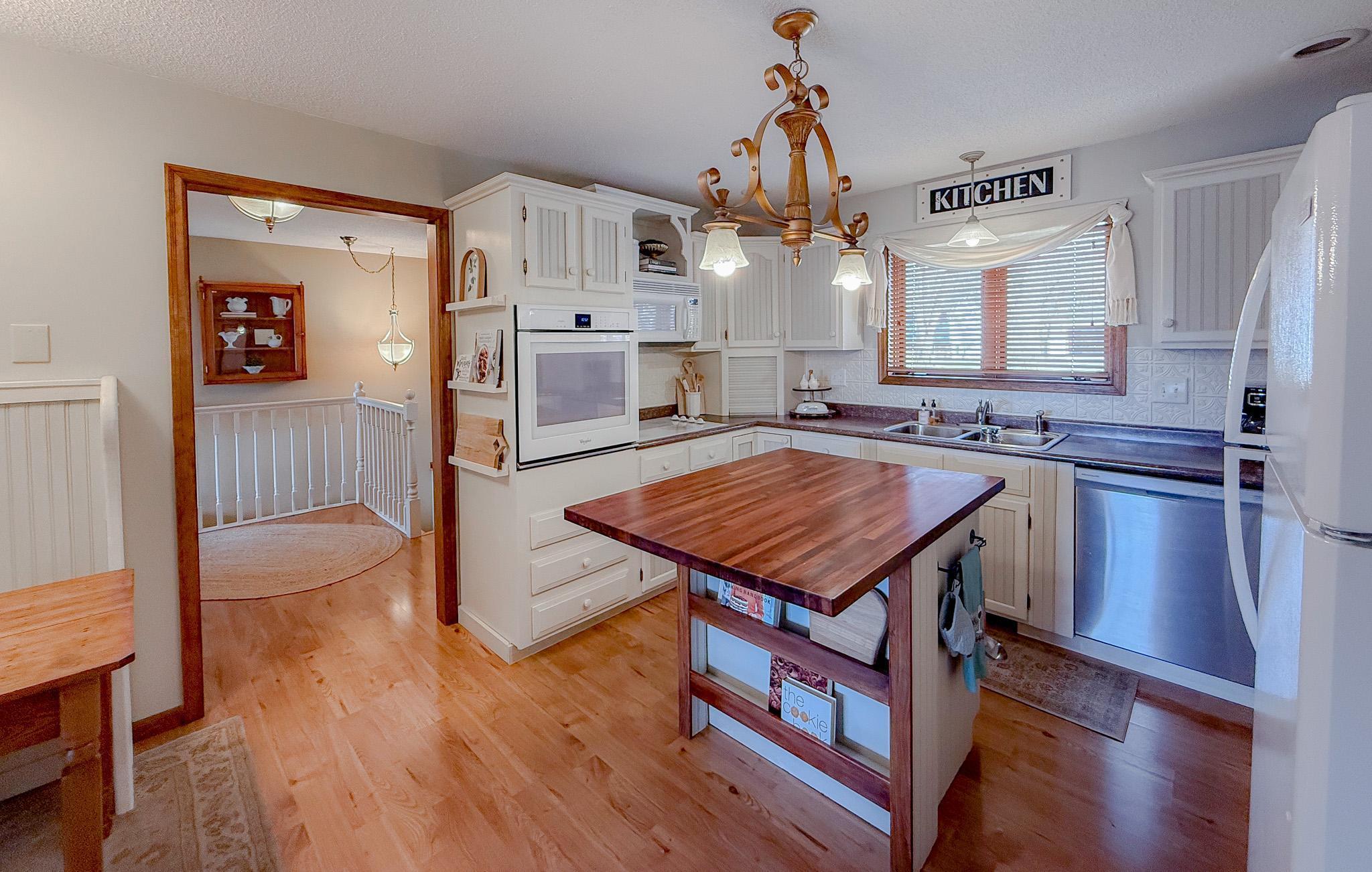 Kitchen offers many custom touches. Cookbook holder, bread box, shelving and plate holders