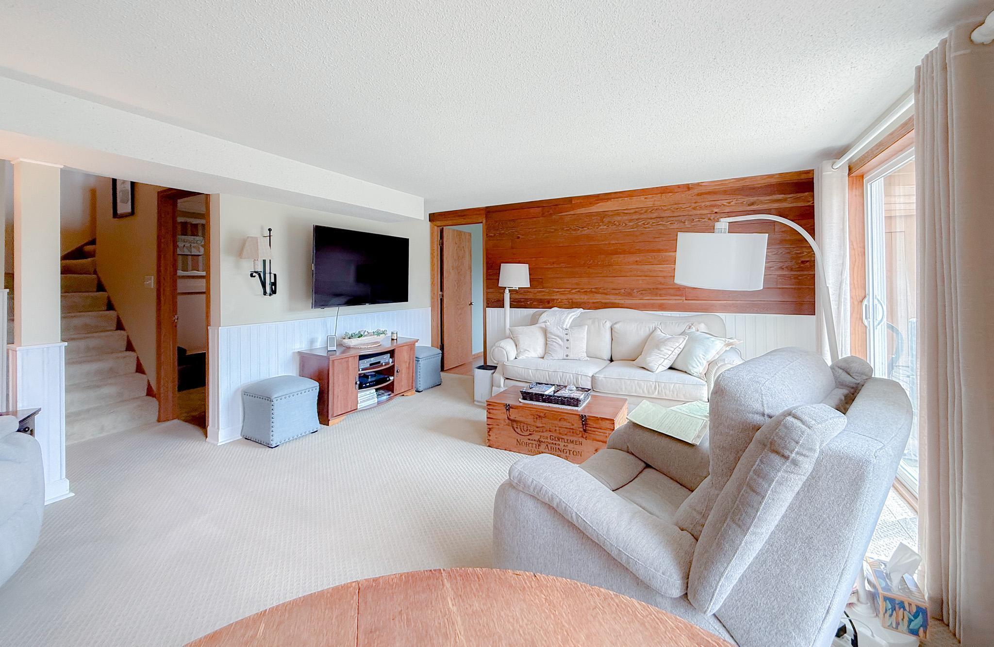 Lower level family room with custom wall. Wall is made from original flooring
