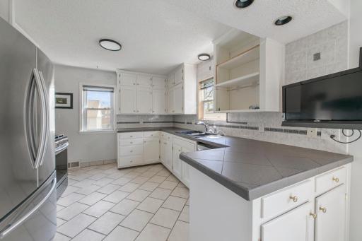 Bright, spacious kitchen with plenty of cabinet space and natural light. Clean and functional