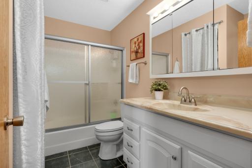 Full bathroom with dual access from hallway and primary.