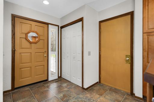 Spacious entryway with coat closet and direct garage access.