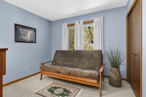 Upper-level bedroom #2 overlooking serene backyard retreat.
