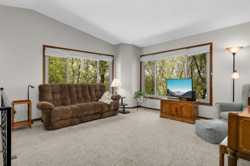 Upper-level living space surrounded by windows, creating a light-filled and airy feel.