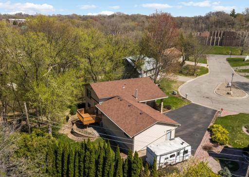 Nestled among mature trees on a wooded lot.