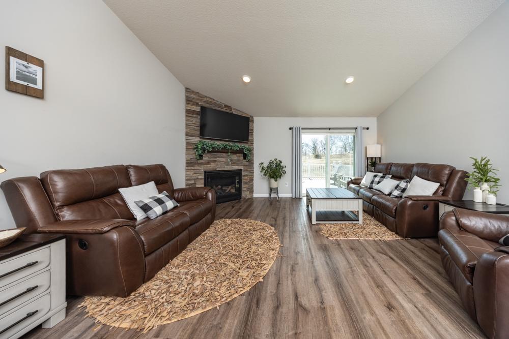 Spacious living room with custom gas fireplace and door leading out to your own private outdoor oasis