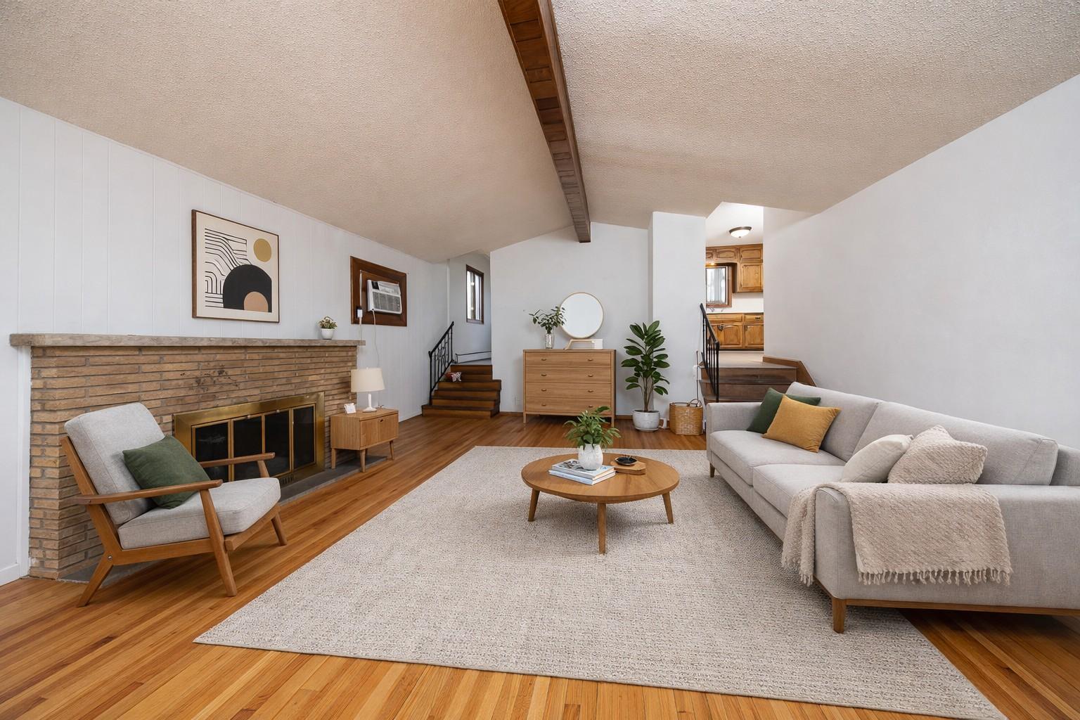 Spacious living room features a vaulted ceiling. Virtually staged photo