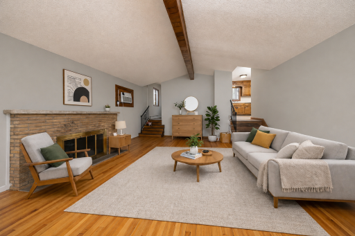 Spacious living room features a vaulted ceiling. Virtually staged photo