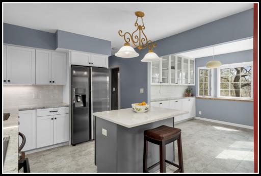 New flooring runs through the kitchen and into the informal dining area