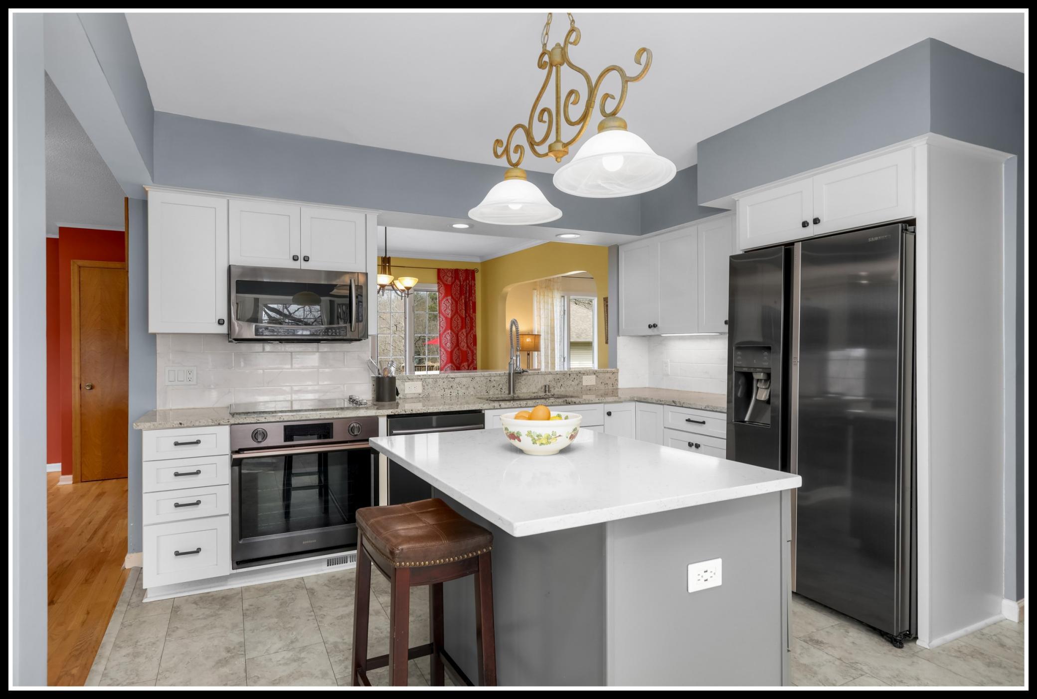Recently updated, the kitchen features modern upgrades . . .