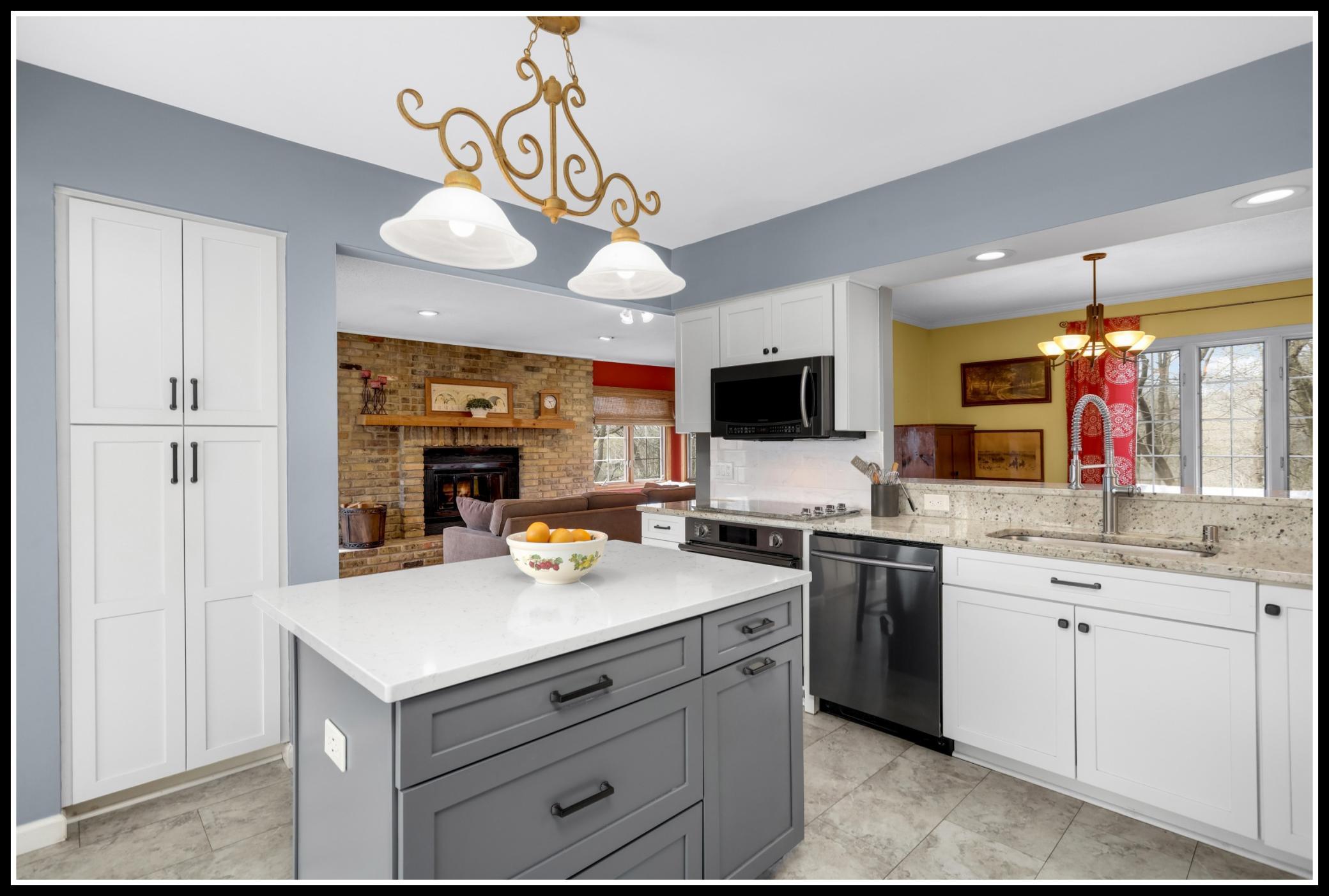 New cabinets, solid surface counters, tiled backsplash, and stainless steel appliances