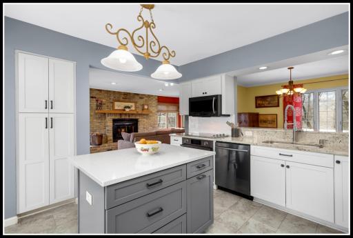 New cabinets, solid surface counters, tiled backsplash, and stainless steel appliances