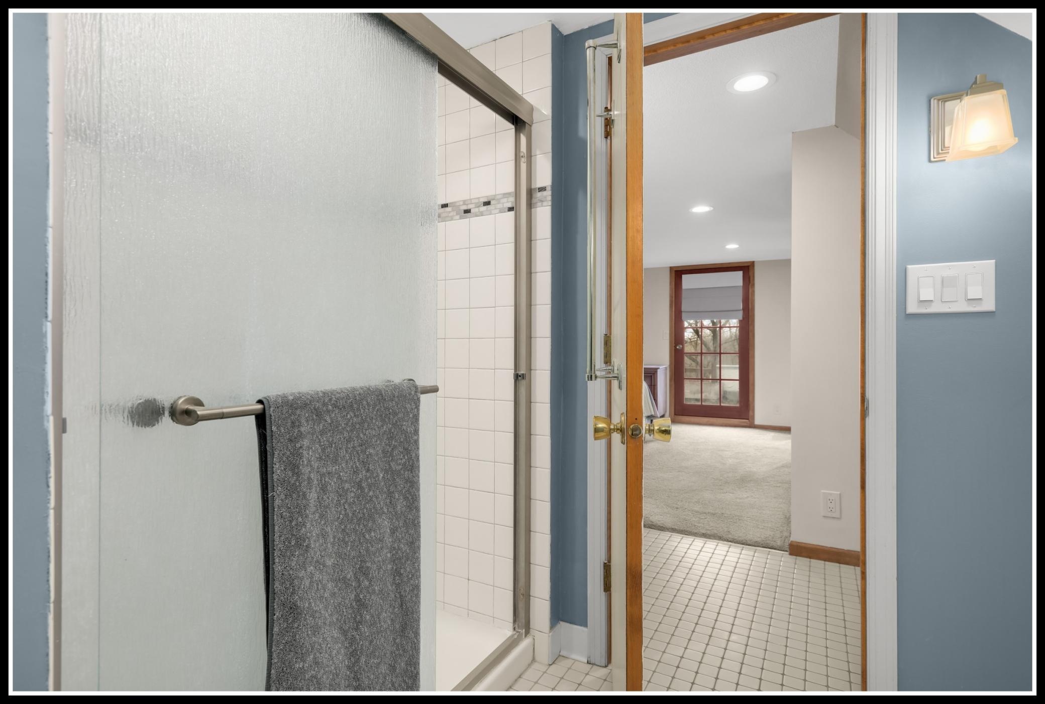 Step-in shower in the upper level walk-though bathroom