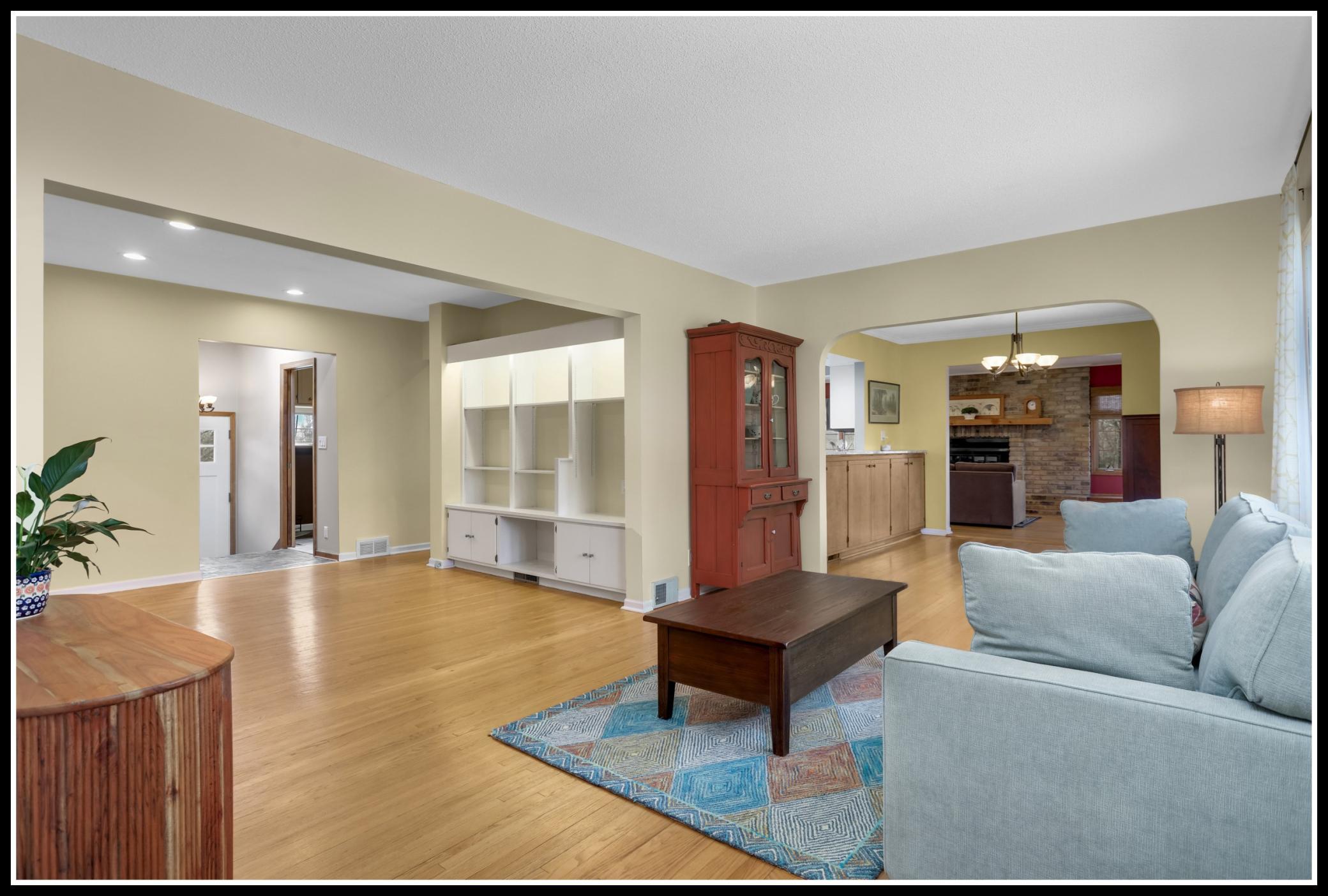 Well-preserved 1940s hardwood floors flow through the sitting room, living room, and dining room