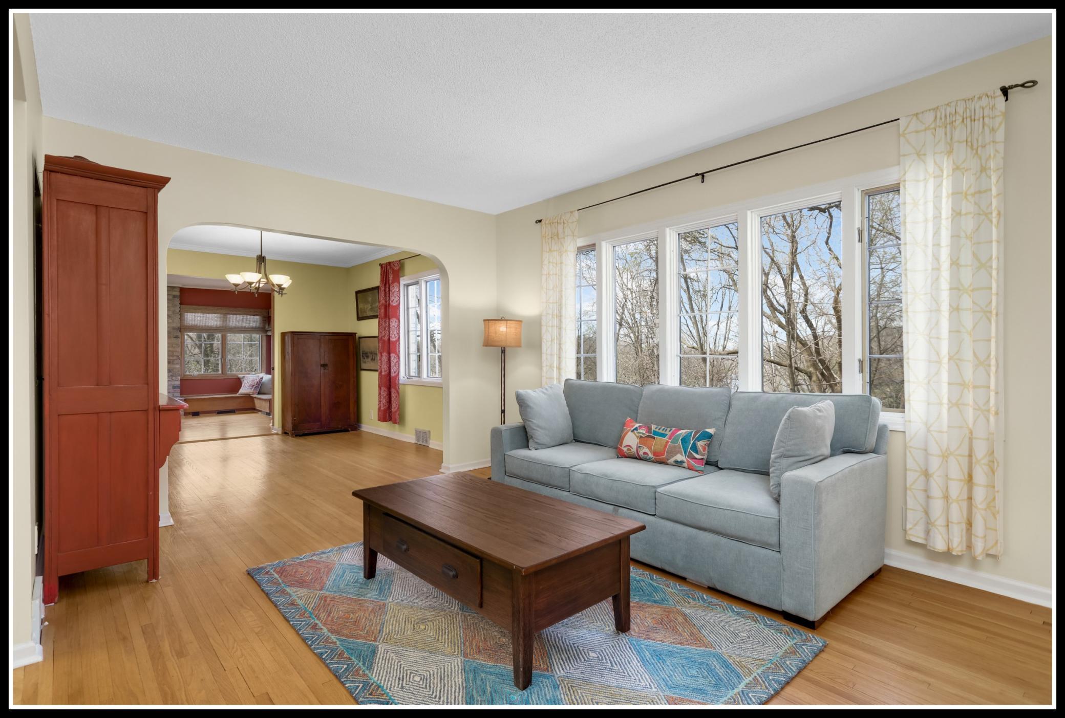 A wall of picture windows looks out to the wooded yard and over Wing Lake