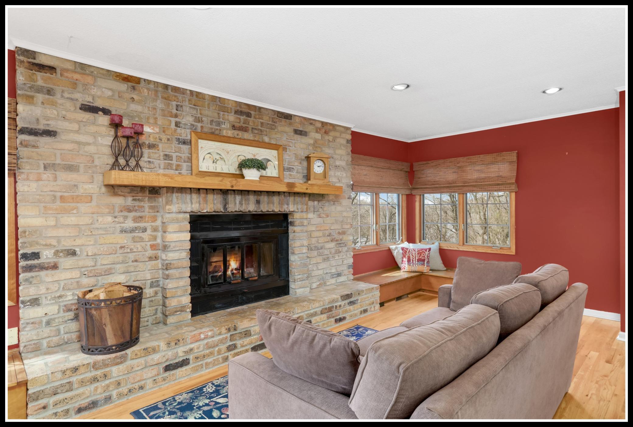A brick-surround wood-burning fireplace offers a cozy ambiance and extra warmth