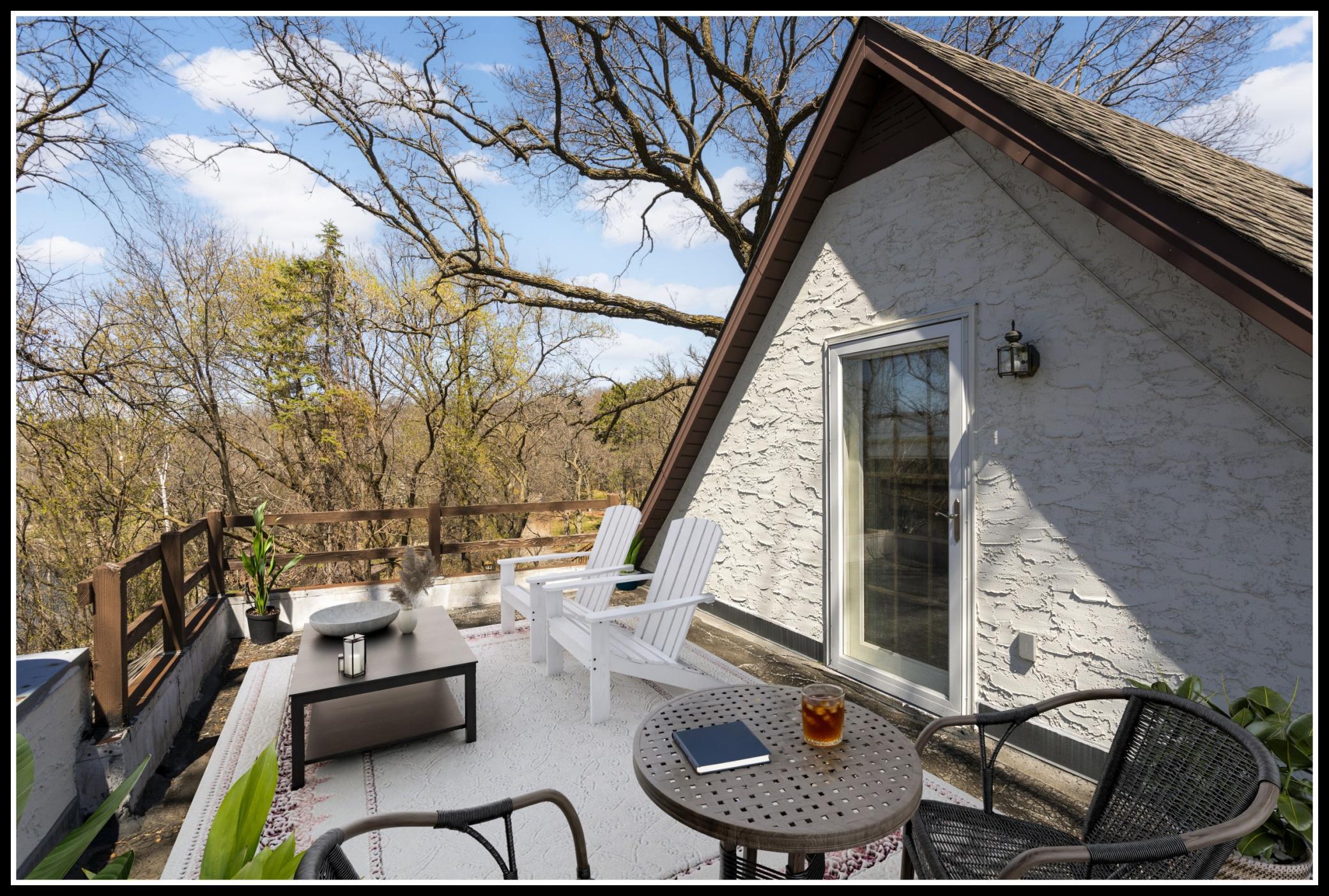 A huge balcony outside the primary suite feels like a treehouse with views of Wing Lake (virtually staged)