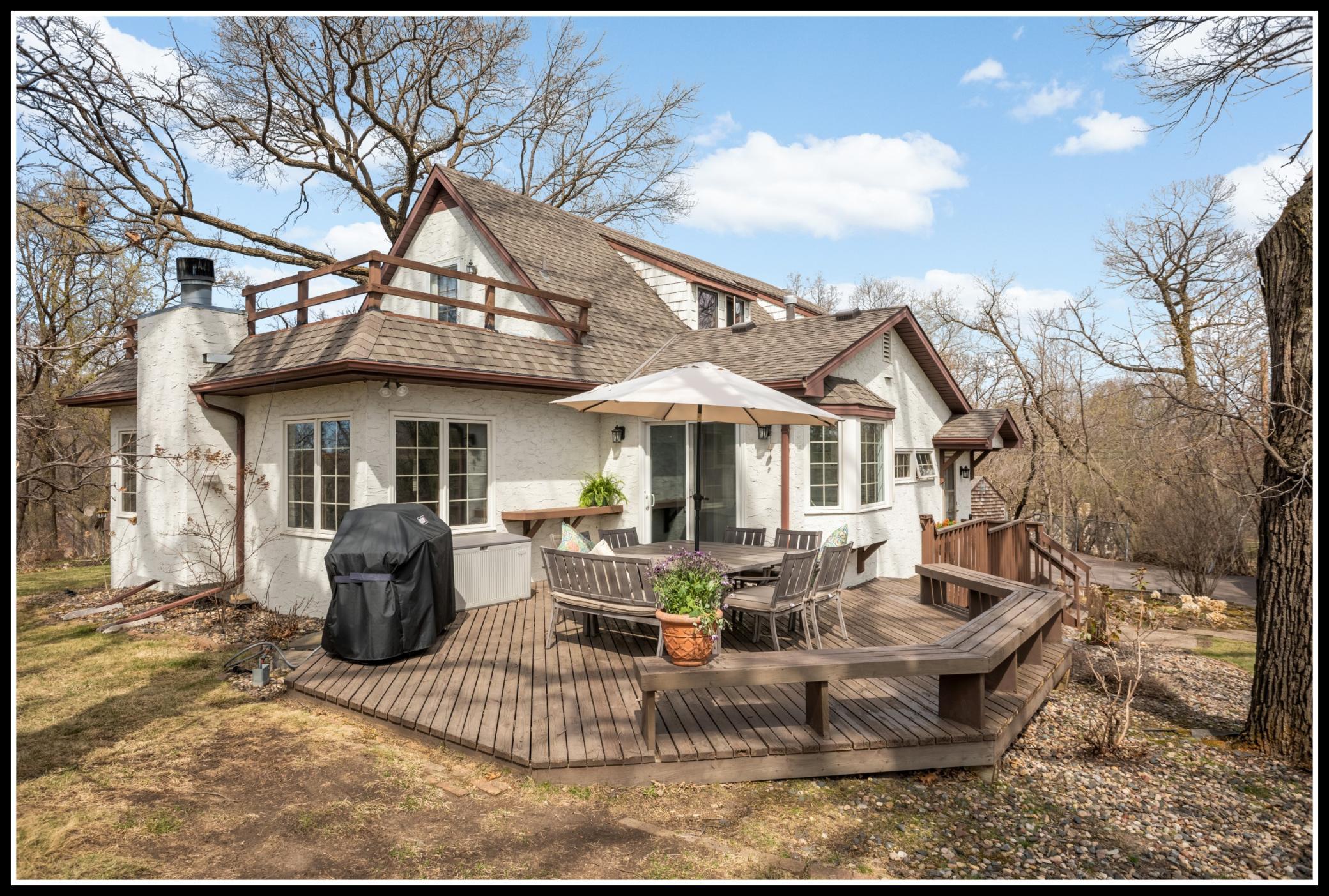 A large wood deck offers space for grilling, seating, dining, and outdoor enjoyment