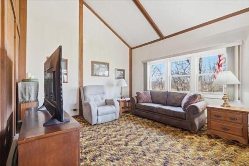 Main level living room with large windows.