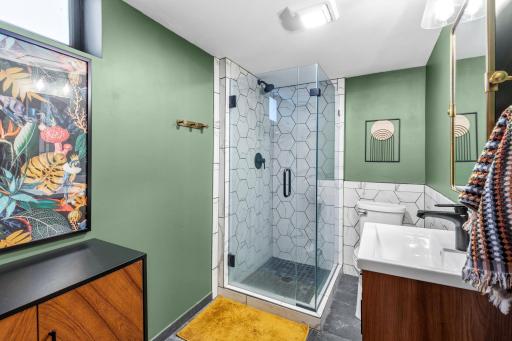 Beautifully updated lower level 3/4 Bath. The shower and floor feature elegant tiles.