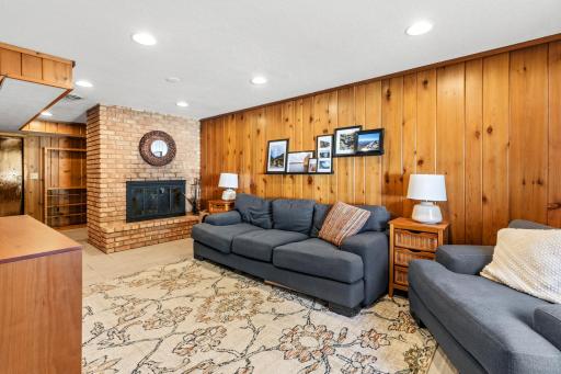 The lower level also features a beautiful brick fireplace.