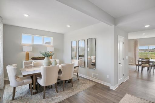 Front formal dining room or flex space. Photo of prior model home, colors and finishes will vary.