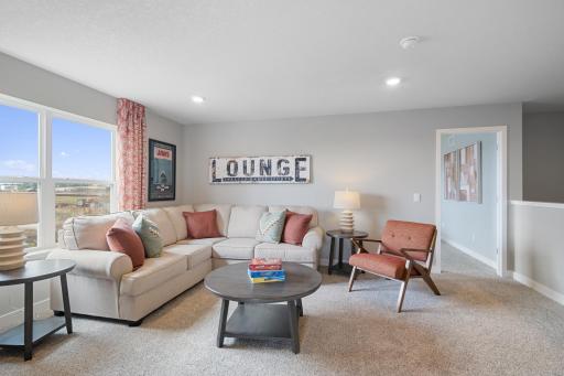 Loft on the upper level serves as a second family room. Photo of prior model home, colors and finishes will vary.