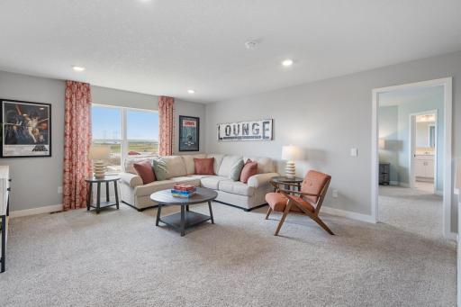 Loft on upper level offers a ton of living options. Leave the games and puzzles out! Photo of prior model home, colors and finishes will vary.
