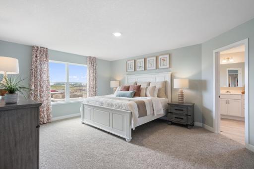 Primary bedroom is spacious yet cozy. Photo of prior model home, colors and finishes will vary.