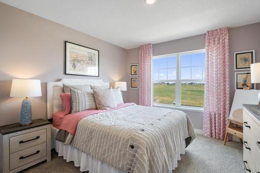 Upper level bedroom 2. Photo of prior model home, colors and finishes will vary.