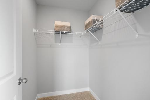 All upper level bedrooms have a walk in closet. Photo of prior model home, colors and finishes will vary.