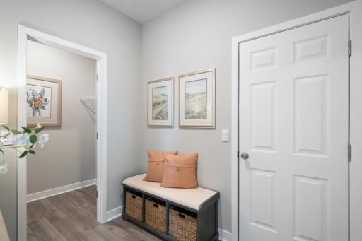 Wonderful mudroom right off the garage helps contain the chaos. Photo of prior model home, colors and finishes will vary.