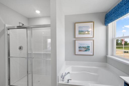 Walk in shower and soaking tub in primary bath.