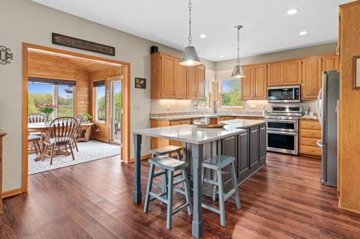 Walk out to the 4-season porch! This is another great space to use as you like. It is fun to have options and be creative!