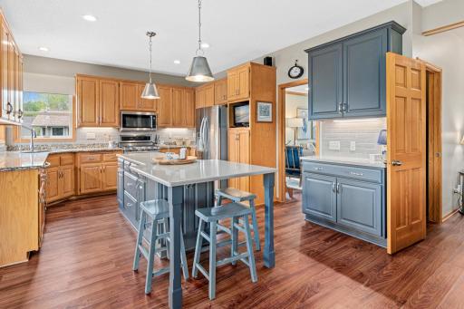 Kitchen with center island includes a kitchen garage to hide the appliances, serving counter, built in eating space. The stools stay with the home.