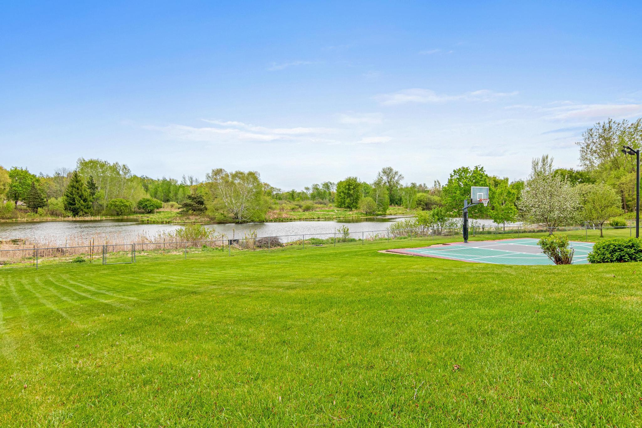 This large lot offers ample room for play. Gate at the back of the yard to get to the pond for skating in the winter months!