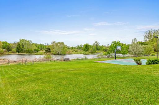 This large lot offers ample room for play. Gate at the back of the yard to get to the pond for skating in the winter months!