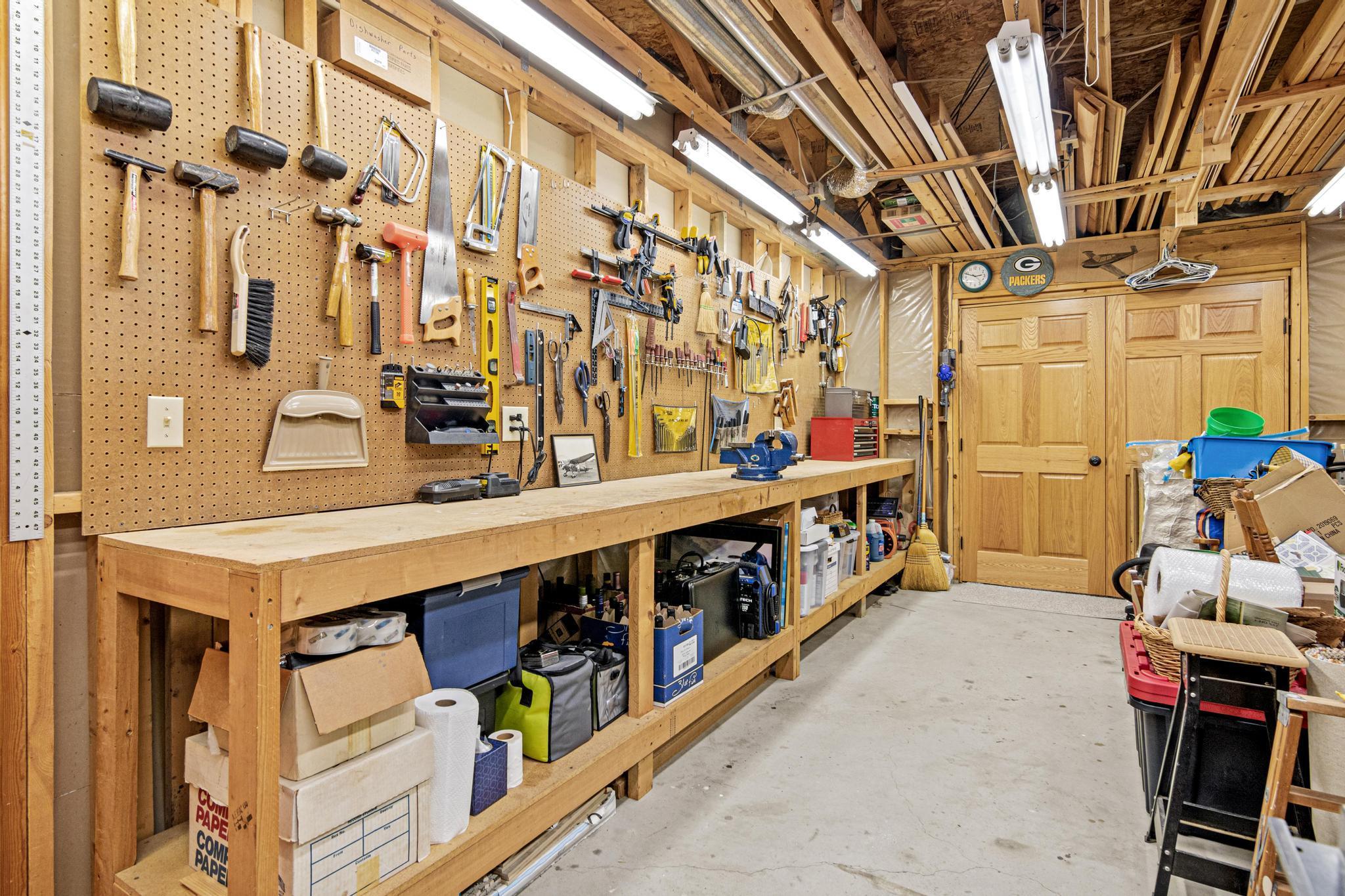 Looking for a Hobby Room? This is a craftsman's paradise! Plenty of room for your tools! This could be finished off into more living space if desired. The double doors enter the family room. *The workbench will be going with the sellers.