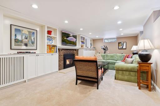 Large lower level family room with built-ins and gas fireplace