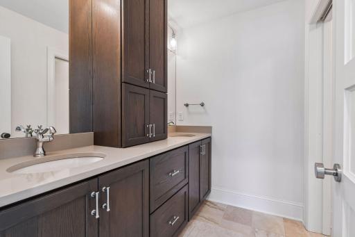 The second floor bath features a dual vanity with a separate stool and shower area