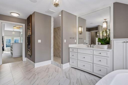 There is a walk in shower with dual heads and an adjoining walk in closet