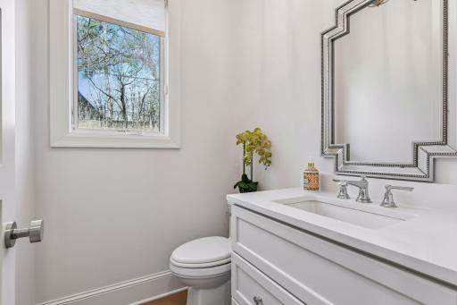 The main floor half bath is conveniently located near the kitchen