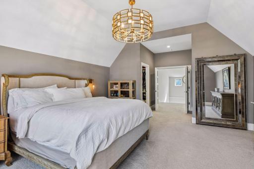 French doors lead to the luxurious owner's suite with a vaulted ceiling