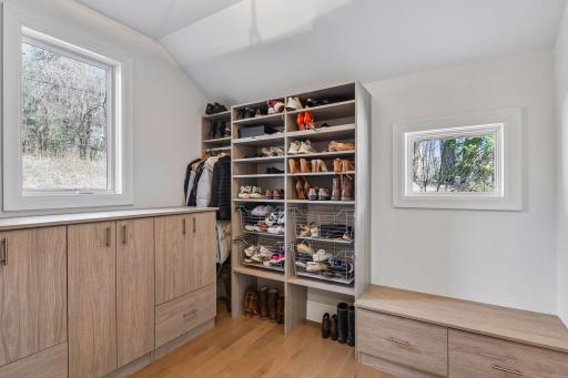 The mudroom has built in cabinets with an abundance of organized storage