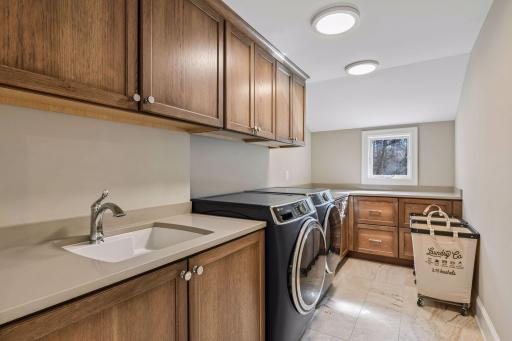 The second floor laundry has GE appliances, a utility sink and tons of workspace