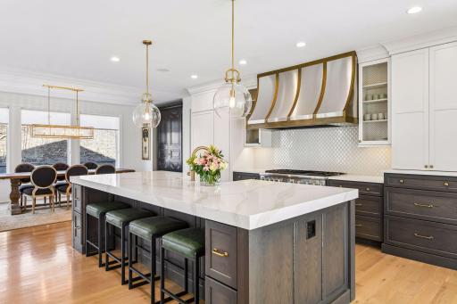 The kitchen features an 11x5 center island and a custom designed vent hood