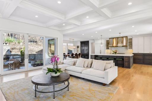 The great room is accentuated with wide plank oak flooring and a 10' high coffered ceiling