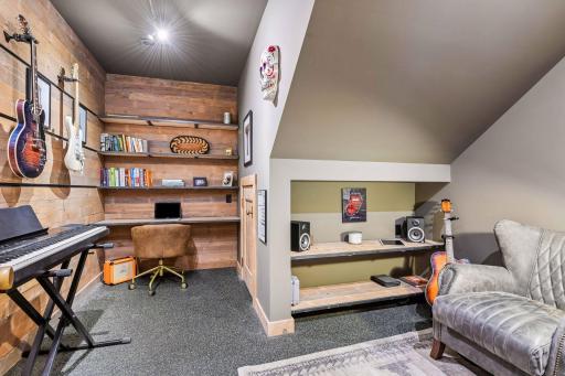 The music studio provides a wonderful oasis with space to display your guitars