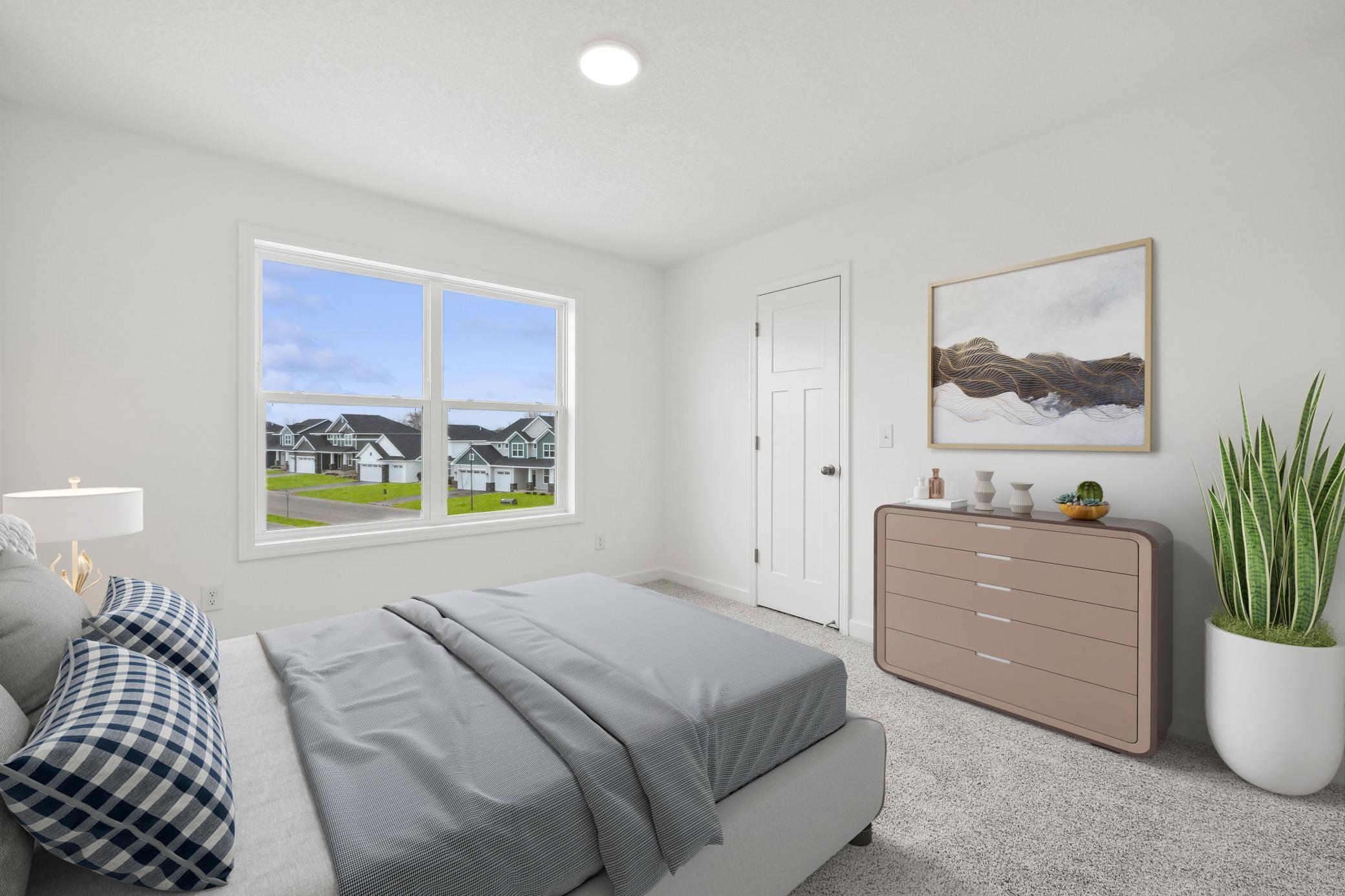 (Photo of a decorated model, actual homes finishes and colors will vary) One of three secondary bedrooms.